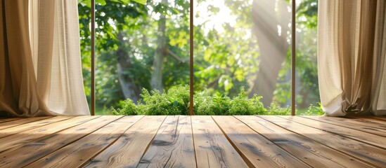Wooden table top is clear against a blurred backdrop of curtains and a green garden view from a window. Ideal for showcasing products or creating visual design layouts.