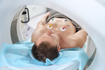 Patient is getting contrast-enhanced ECG-gated coronary computed tomography