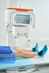 Male person is undergoing digital x-ray of knees