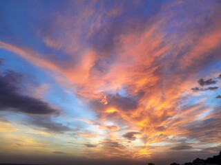 Stunning colorful clouds at the sky. Amazing view of the dramatic sunset sky