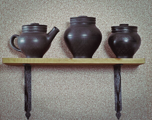 Black rustic pottery on shelf