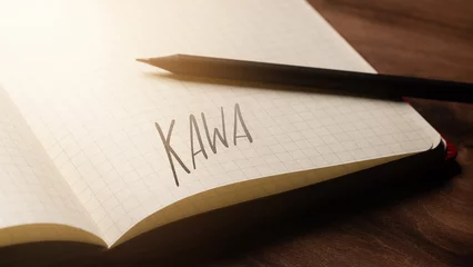 Fotobehang A handwritten inscription "Kawa" on a grille of an open notebook on a wooden countertop, next to a black pencil, lighting of light. (selective focus), translation: coffe © Jakub