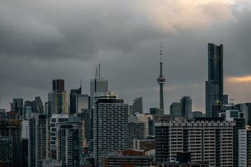 Fototapeta premium Toronto city downtown skyline, clouds over CN Tower and skyscrapers of financial district Canada