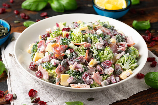 Healthy Homemade Broccoli Salad with bacon, red onion, cranberries, pumpkin seeds and cheese