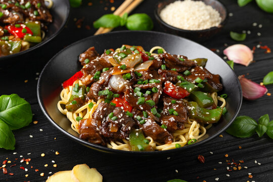 Stir fried beef in black bean sauce with vegetables and noodles. Take away food