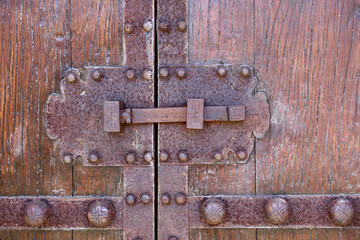 ancient wood door with rusty iron hardware