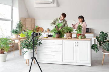 Couple of bloggers with plants recording video at home