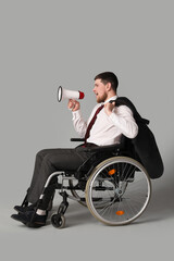 Businessman in wheelchair shouting into megaphone on light background