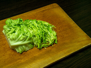 Chopped young green cabbage on a board