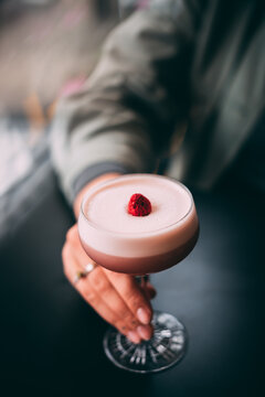 Summer vibe cocktail in martini glass, decorated with berry
