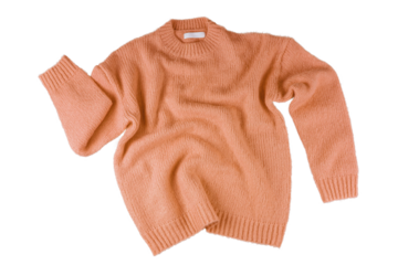 Orange flying crumpled women's autumn knitted sweater isolated on white, transparent background. Creative clothing concept, trendy cozy creasy jersey pullover. Fashion, sale, autumn discount