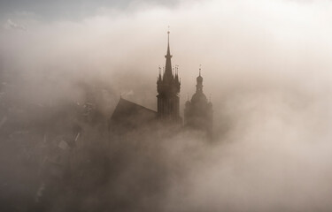 Saint Mary Basilica (Mariacki Church) during foggy sunrise, Krakow, Poland
