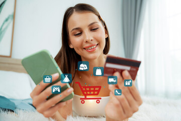 Customer lying down wearing white tank top holding credit card typing phone choose online platform....