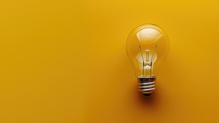 Clear lightbulb on yellow background with ample copy space