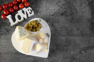brie, camembert, gorganzola with olives and cherry tomatoes. Soft cheese with white and blue mold, olives and olive oil, a glass of red wine on a gray marble background. - 791132689