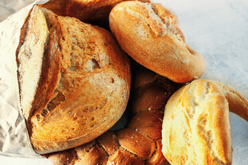 Assortment of bakery products. Challah, braided bread ring, kalachi, round rye bread. The concept...