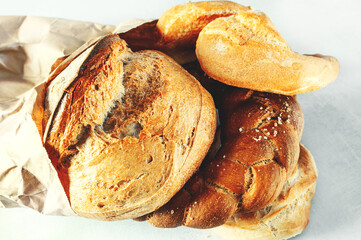 Assortment of bakery products. Challah, braided bread ring, kalachi, round rye bread. The concept...