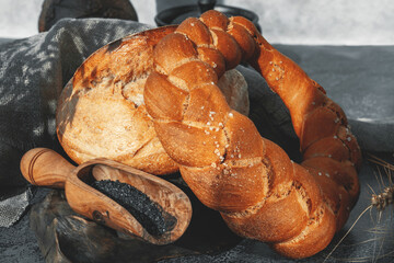 Assorted bread made from wheat and rye sourdough. Rich challah and round rye bread with black salt....