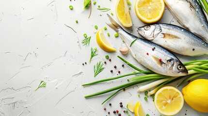 Fresh sprats with green onion spices and lemon slices on a white table in a close up shot - obrazy, fototapety, plakaty