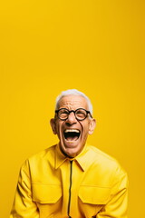 A senior man with glasses is captured mid-laugh, dressed in a vibrant yellow jacket that matches the backdrop, radiating joy and positivity - Generative AI