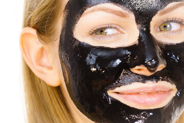 Woman with black peel off mask on face