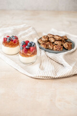 Gourmet meatballs on a rustic plate with a parfait of berries, embodying a casual yet tasteful culinary setup.