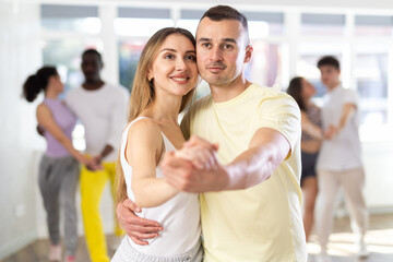 Woman learn to dance couples latin dance, energetic and fast salsa in modern dance salon