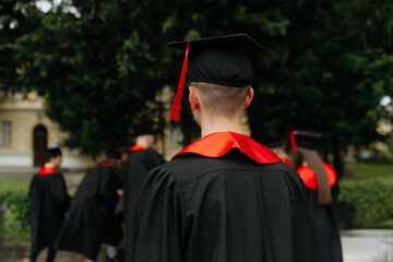 Selective focus on graduation cap of group of students. black uniform of students