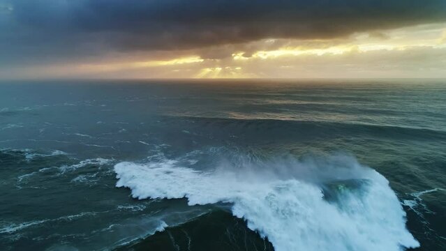 Aerial view on big waves of Atlantic ocean and dramatic sunset sky, 4k