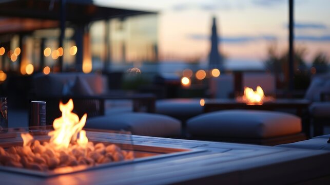 Blurry image of a chic rooftop bar featuring flickering fire pits and comfortable seating arrangements perfect for a relaxing evening under the stars. .