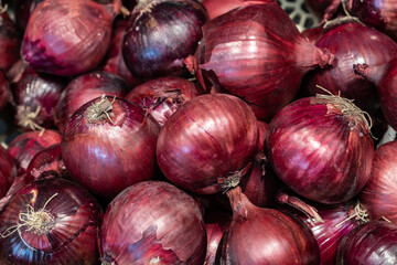 top view lot of fresh big red onions with peel at the grocery