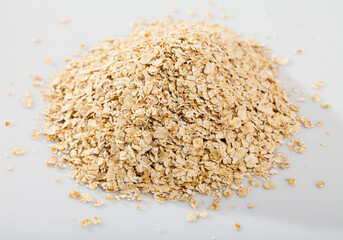 Image of a handful of oatmeal on white background, nobody