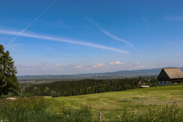 A beautiful panorama of vast Polish meadows against the background of mountains in the Lesser Poland Voivodeship.