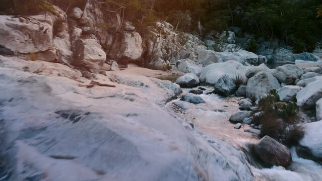 Beautiful aerial drone shot tracking smoothly along a winding river flowing through the scenic landscape of Baja California Sur
