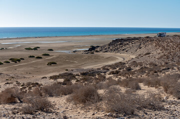 Fototapeta na wymiar Sandy dunes and turquoise water of Sotavento beach, Costa Calma, Fuerteventura, Canary islands, Spain in winter, camper car vacation