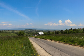 An asphalt road leading through the picturesque landscapes of the Polish mountains. A beautiful car...