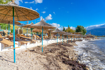 Coast of the city of Vlore, beach with parasols, passage of storm causing dirty water.