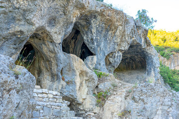 Holes, caves in the stone slopes in the hot spring zone of Permet-Albania.