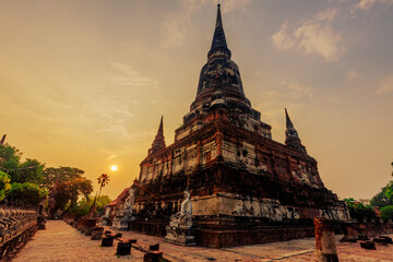 Fototapeta premium The background of important religious attractions, Wat Yai Chai Mongkhon, has an old Buddha statue and a large pagoda for tourists to study the history of Ayutthaya in Thailand.