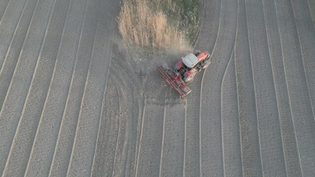 drone image of a working tractor in the field taken from above