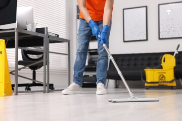 Cleaning service. Man washing floor with mop, closeup