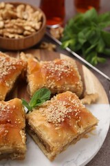 Eastern sweets. Pieces of tasty baklava on brown table, closeup