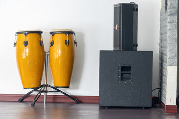 Big yellow bongos set with loud-speaker on a stage