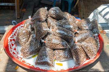 Fish feed - pellets in small plastic bags for sale, Thailand