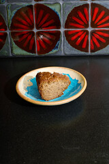 Fresh cake dessert on a plate with a beautiful red tile background. 