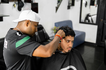 Professional Barber Styling Client's Hair in Salon