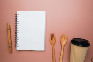 The mock-up notebook with spoon, fork, and coffee cup for meal plan, diet, cooking, recipe, menu,...