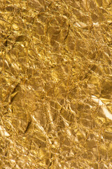 Gold crumpled texture background. Abstract banner with shine gold.