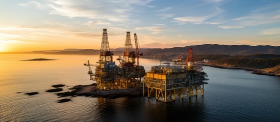 Oil and gas platform in the sea at sunset. Aerial view. - obrazy, fototapety, plakaty