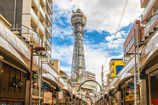 October 7, 2023: Street view of Shinsekai and Tsutenkaku tower in Osaka, Japan. Shinsekai, lit. New World, is a retro area developed before the war and then neglected in the decades afterwards.